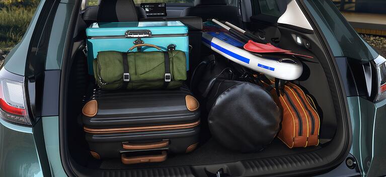 2027 Honda HR-V EX-L cargo area filled with luggage, a cooler, and a paddleboard (Subcompact Crossover SUV).